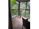 The tiled, screened patio has plenty of plants and chairs overlooking the grounds at 900 La Costa Cir # 4, Sarasota, FL 34237