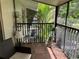 A screened patio with tile floors has plants and a comfortable chair and table at 900 La Costa Cir # 4, Sarasota, FL 34237