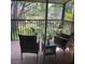 This screened patio has comfortable chairs and a small table to enjoy the weather at 900 La Costa Cir # 4, Sarasota, FL 34237
