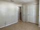 Large, bright room with tile flooring, neutral walls, and sliding door closet at 900 La Costa Cir # 4, Sarasota, FL 34237