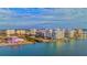 This aerial view showcases the luxurious condo building surrounded by water and the vibrant cityscape at 990 Blvd Of The Arts # 801, Sarasota, FL 34236