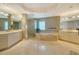 Luxurious bathroom with double sinks, glass shower and soaking tub at 990 Blvd Of The Arts # 801, Sarasota, FL 34236