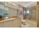 This bathroom features marble counters, shower, and tile at 990 Blvd Of The Arts # 801, Sarasota, FL 34236