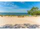 Picturesque beach with inviting chairs, ocean views, and a peaceful atmosphere for relaxation at 990 Blvd Of The Arts # 801, Sarasota, FL 34236