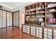 This bedroom features a beautiful built-in shelving unit and stunning wood floors at 990 Blvd Of The Arts # 801, Sarasota, FL 34236
