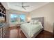Cozy bedroom features hardwood floors, a ceiling fan, and city views at 990 Blvd Of The Arts # 801, Sarasota, FL 34236