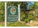 Inviting sign for Sarasota Botanical Gardens surrounded by green foliage, welcoming visitors to explore nature at 990 Blvd Of The Arts # 801, Sarasota, FL 34236