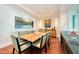 Cozy dining room enhanced by recessed lights, modern artwork and a table seating for eight at 990 Blvd Of The Arts # 801, Sarasota, FL 34236