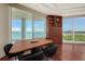 Bright dining room features wood floors, water views, and a modern display case at 990 Blvd Of The Arts # 801, Sarasota, FL 34236