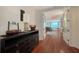Inviting foyer featuring hardwood floors, a console table, and glass doors leading to the living area at 990 Blvd Of The Arts # 801, Sarasota, FL 34236