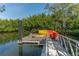 Dock with colorful kayaks ready for a day on the water, surrounded by lush greenery and calm waters at 990 Blvd Of The Arts # 801, Sarasota, FL 34236