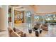 Expansive lobby features modern decor, marble floors, and floor-to-ceiling windows with lush outdoor views at 990 Blvd Of The Arts # 801, Sarasota, FL 34236