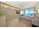 Serene main bedroom boasts custom storage, a ceiling fan, and stunning water views at 990 Blvd Of The Arts # 801, Sarasota, FL 34236