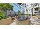 Outdoor kitchen featuring a granite countertop, built-in grill, and a sink, surrounded by lush greenery at 990 Blvd Of The Arts # 801, Sarasota, FL 34236