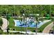 Modern playground with unique play structures, lush landscaping, and ample seating areas at 990 Blvd Of The Arts # 801, Sarasota, FL 34236