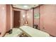 Calm spa room featuring a massage table, chair, and art, decorated with warm colors and soft lighting at 990 Blvd Of The Arts # 801, Sarasota, FL 34236