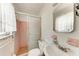 Small bathroom featuring a pink tiled shower and white sink at 10095 Nassau Ct, Seminole, FL 33776