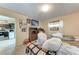 View of a bedroom featuring two twin beds, linoleum flooring, and view into the kitchen area at 10095 Nassau Ct, Seminole, FL 33776