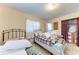 Simple bedroom with twin beds, neutral walls, and a closet at 10095 Nassau Ct, Seminole, FL 33776