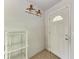 Simple entryway featuring white walls and adjacent shelf at 10095 Nassau Ct, Seminole, FL 33776