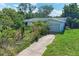Quaint single-story home featuring an attached garage and mature landscaping at 10095 Nassau Ct, Seminole, FL 33776