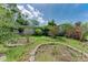 Exterior featuring stone planters and an overgrown landscape at 10095 Nassau Ct, Seminole, FL 33776