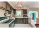 Functional kitchen with dark wood cabinets, tile floors, and view to the dining room at 10095 Nassau Ct, Seminole, FL 33776