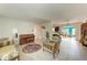 Spacious living room with tile flooring, vintage furniture, and an archway to the dining room at 10095 Nassau Ct, Seminole, FL 33776