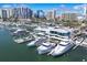 Expansive aerial view of a marina featuring yachts docked in the foreground and city buildings in the background at 101 S Gulfstream Ave # 15C, Sarasota, FL 34236