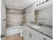 Well-lit bathroom with a shower-tub combo, modern fixtures, and granite countertops at 101 S Gulfstream Ave # 15C, Sarasota, FL 34236