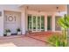 Condominium exterior entrance with glass doors, brick pathway, and landscaped planters at 101 S Gulfstream Ave # 15C, Sarasota, FL 34236