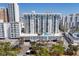 Exterior view of condo with poolside amenities on top of garage overlooking lush trees and the city at 101 S Gulfstream Ave # 15C, Sarasota, FL 34236