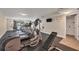 Gym featuring treadmills, elliptical, weight bench, television and rubber flooring at 101 S Gulfstream Ave # 15C, Sarasota, FL 34236