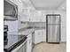 Modern kitchen featuring white cabinets, granite countertops, and stainless steel appliances at 101 S Gulfstream Ave # 15C, Sarasota, FL 34236