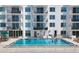 Bright community pool with turquoise water and balcony views on a sunny day at 101 S Gulfstream Ave # 15C, Sarasota, FL 34236