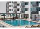 Inviting community pool featuring lounge seating and umbrella-shaded tables by the building at 101 S Gulfstream Ave # 15C, Sarasota, FL 34236