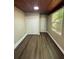 Bedroom showcasing wood panel ceiling and vinyl flooring at 1132 26Th S Ave, St Petersburg, FL 33705