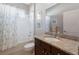 Bathroom with granite countertop, under-sink cabinets, and shower at 11610 Griffith Park Ter, Bradenton, FL 34211