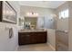 Bathroom with a double sink, glass shower, and decorative lighting at 11610 Griffith Park Ter, Bradenton, FL 34211