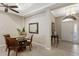 A dining room with a glass table, four chairs, access to the foyer, and decor at 11610 Griffith Park Ter, Bradenton, FL 34211
