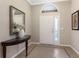 Elegant foyer with tile flooring, a decorative table, and a stylish mirror creating a warm and inviting entrance at 11610 Griffith Park Ter, Bradenton, FL 34211