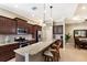 Modern kitchen with granite countertops, stainless steel appliances, and a breakfast bar for convenient and stylish dining at 11610 Griffith Park Ter, Bradenton, FL 34211