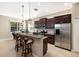 This kitchen features stainless steel appliances, dark wood cabinets, and an island with bar seating at 11610 Griffith Park Ter, Bradenton, FL 34211