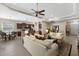 Bright living room with an open-concept design showcasing the kitchen, dining area, and seamless integration for modern living at 11610 Griffith Park Ter, Bradenton, FL 34211