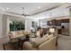 Spacious living area with couches, an open-concept kitchen, tray ceilings, and natural light for comfortable modern living at 11610 Griffith Park Ter, Bradenton, FL 34211