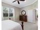 Main bedroom featuring carpeted floors, a ceiling fan, a large dresser, and decor at 11610 Griffith Park Ter, Bradenton, FL 34211