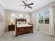 Main bedroom with a ceiling fan, large windows, side tables, and decor at 11610 Griffith Park Ter, Bradenton, FL 34211