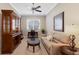 Office/den area with a sofa, desk, window, ceiling fan, and decor at 11610 Griffith Park Ter, Bradenton, FL 34211