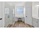 Bright bathroom with glass shower, desk, and wood look flooring at 13640 2Nd E Ave, Bradenton, FL 34212