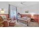 Bright bedroom featuring a brass bed frame, accent chair and ottoman at 13640 2Nd E Ave, Bradenton, FL 34212